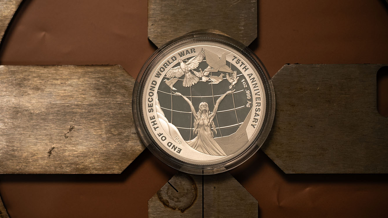 End of the second world war coin with lady, doves and origami design