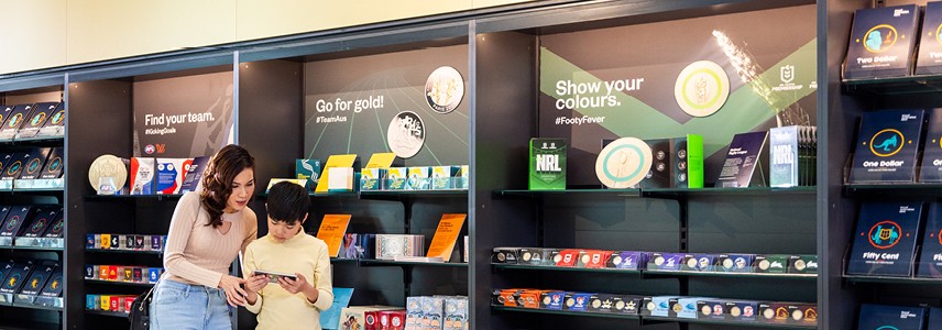 A mother and son viewing coins in the Mint Shop.