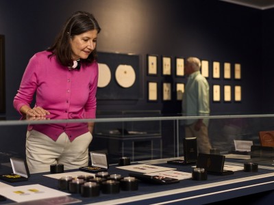Honours Exhibition with woman looking at the display case