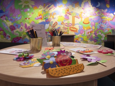 A desk with colouring activities in the Mint's Tooth Fairy Workshop room.