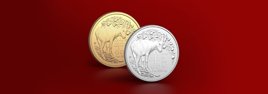 Gold and silver Lunar Year of the Goat investment coins against a red background.
